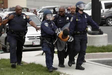 BALTIMORE, MD - APRIL 27: Baltimore Police officers arrest a man near Mowdamin Mall, April 27, 2015 in Baltimore, Maryland. The funeral service for Freddie Gray, who died last week while in Baltimore Police custody, was held on Monday morning. (Drew Angerer/Getty Images)