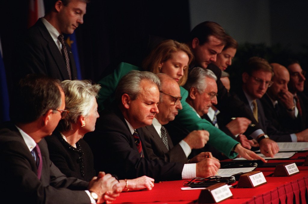 Seated from left to right: Slobodan Milošević, Alija Izetbegović, Franjo Tuđman initialling the Dayton Peace Accords at the Wright-Patterson Air Force Base on 21 November 1995.