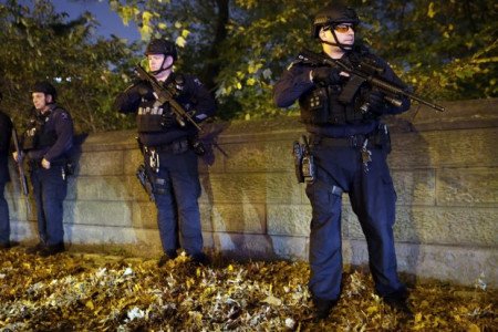 Heavily armed New York City police officers stand guard across the street from the French consulate on New York's Fifth Avenue on Friday. PHOTO: MARY ALTAFFER/ASSOCIATED PRESS