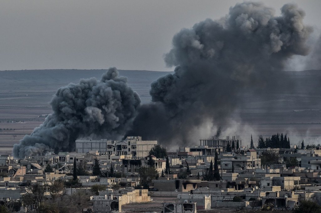Smoke rises after an airstrike from US-led coalition in the city of Kobane, also known as Ain al-Arab, seen from the southeastern border village of Mursitpinar, Sanliurfa province, on November 9, 2014., Image: 210517893, License: Rights-managed, Restrictions: , Model Release: no, Credit line: Profimedia, AFP