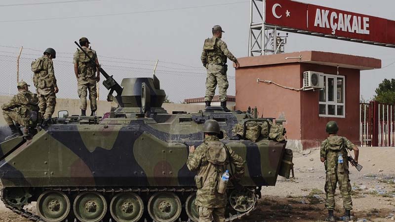Turkish soldiers patrol a military station at the border crossing with Syria in Akçakale