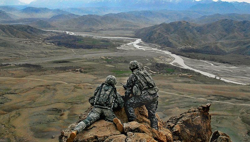 U.S. Army 1LT Jared Tomberlin (left) from Bravo Company, 1st Battalion, 4th Infantry Regiment gets a first hand view of the land with outgoing commander 1LT Larry Baca from Charlie Co. 1-4, on top of a ridge near Forward Operation Base Lane, Zabul Province, Afghanistan, on February 21, 2009. (U.S. Army photo by Staff Sergeant Adam Mancini / Released)