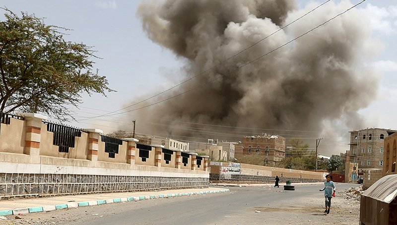 A girl runs for shelter during an air strike in Sanaa on April 8, 2015Khaled Abdullah Ali/Reuters