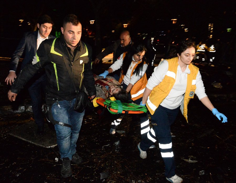 ANKARA, TURKEY - MARCH 13: (EDITORS NOTE: Image contains graphic content.) Emergency services help an injured person following after an explosion in Ankara's central Kizilay district on March 13, 2016 in Ankara, Turkey. The Ankara governor's office has reported that at least 27 people have been killed and 75 wounded in an explosion in the Turkish capital Ankara. The explosion is believed to have been a car bomb attack according to Ankara governor Mehmet Kiliclar. (Photo by Defne Karadeniz/Getty Images)