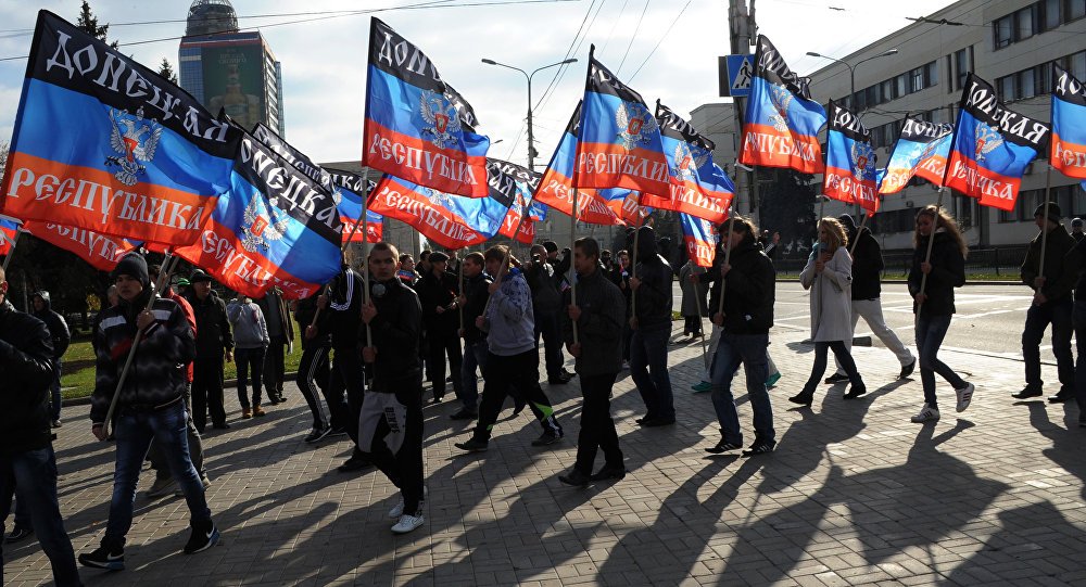 Citizens carry flags of the Donetsk People's Republic
