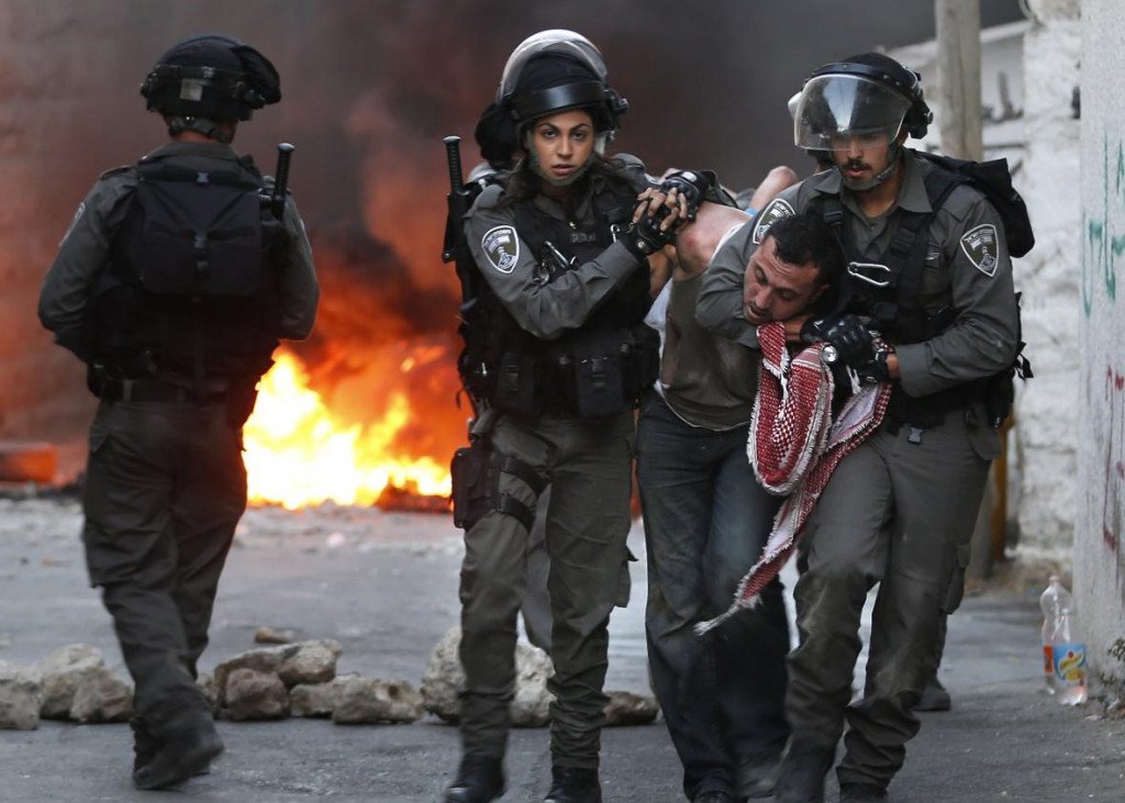 Israeli security forces arrest a Palestinian during clashes in the Palestinian neighborhood of Shuafat in east Jerusalem on October 5, 2015 as violence spiked in east Jerusalem and the West Bank. Photo by AHMAD GHARABLI/AFP/Getty Images