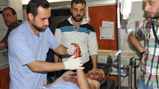 A handout picture released by Syria’s official SANA news agency on June 11, 2016 shows a doctor treating a wounded victim at a hospital in Damascus. ©AFP