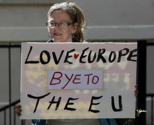 A woman holds a sign in Westminster, in central London, Britain June 24, 2016.     REUTERS/Phil Noble