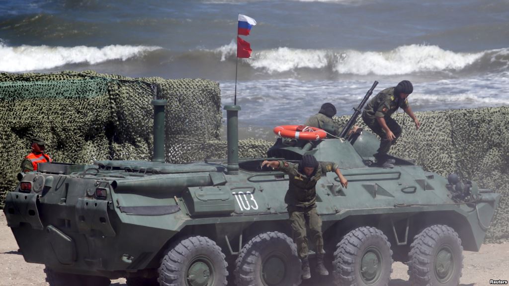 FILE - Russian navy personnel are seen disembarking from an armored personnel carrier (APC) in Kaspiysk, Russia, Aug. 5, 2015.