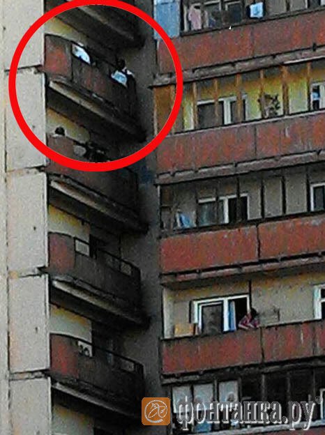 People in chemical protection suits on two balconies.