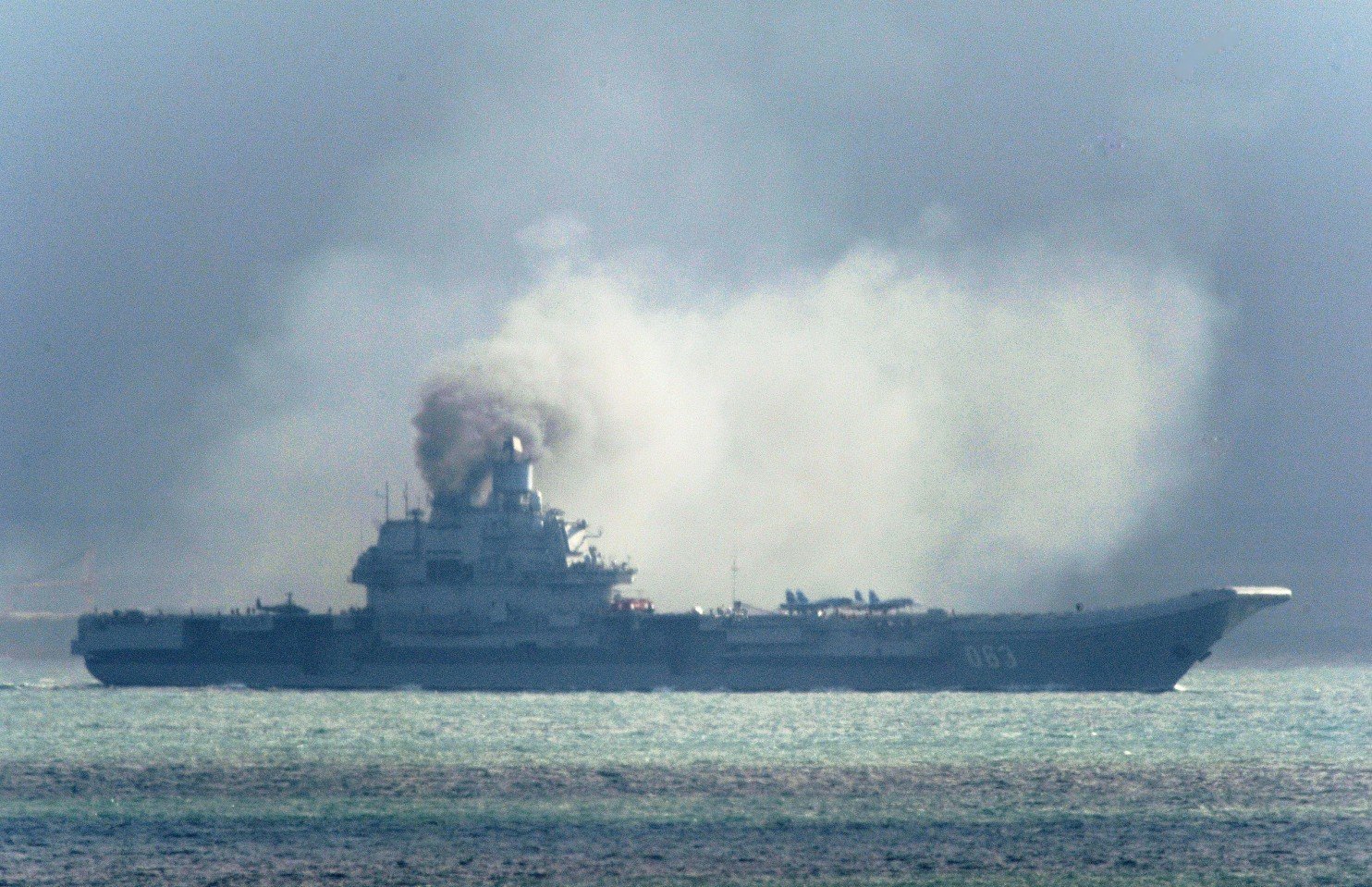 The Russian aircraft carrier Admiral Kuznetsov passes within a few miles of Dover, in the southeast of England as a fleet of Russian warships sail through the North Sea, and the English Channel Friday Oct. 21, 2016. Britain is sending warships to watch a Russian aircraft carrier group and other vessels as they sail through the North Sea and the English Channel. Defense Secretary Michael Fallon said Thursday, that the military will watch “every step of the way.” (Gareth Fuller/PA Wire (Associated Press)
