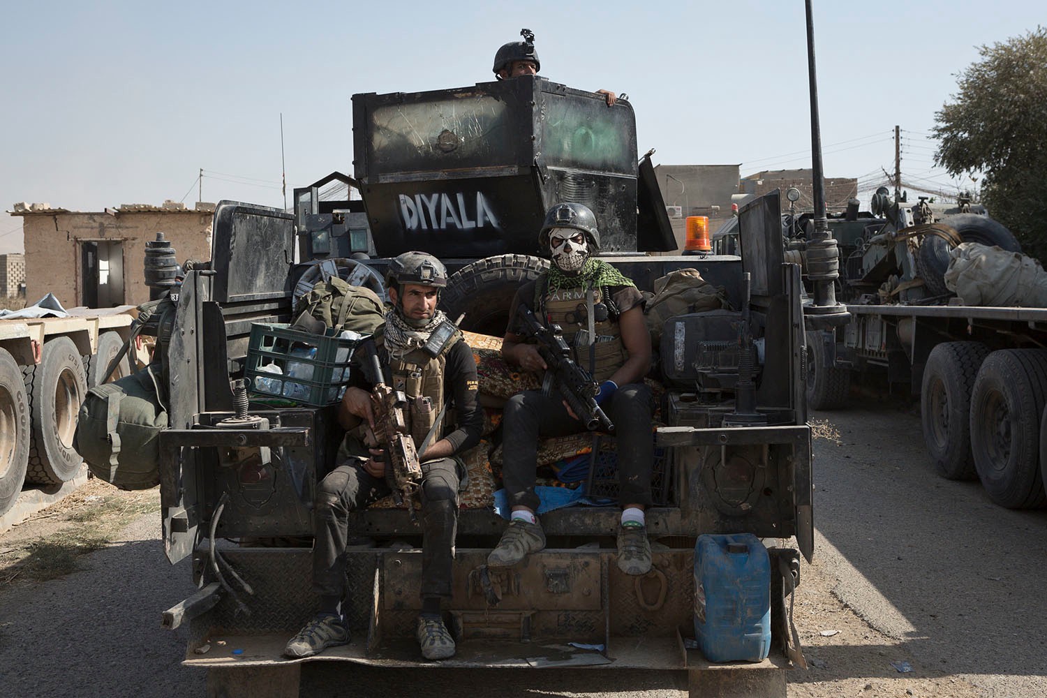 Iraqi Army Golden Brigade soldiers travel through Bartella on the back of an armored Humvee. Matt Cetti-Roberts photo