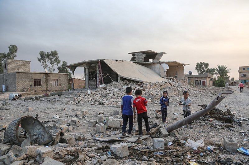 Fig.3 Children of Mosul play on ruins