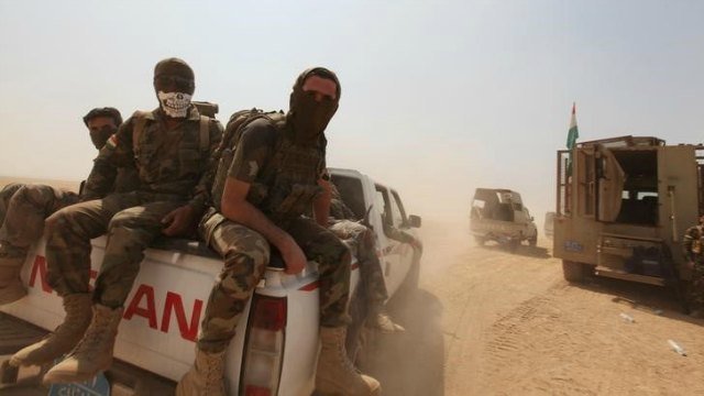 Kurdish Peshmerga forces ride on military vehicles on the southeast of Mosul, Iraq, August 14, 2016. (Reuters)
