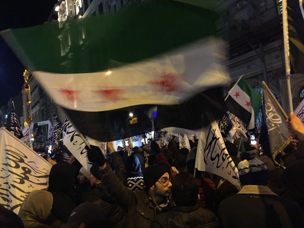 Protesters with the flags of Jabhat al-Nursa and the so-called "Free Syrian Army"