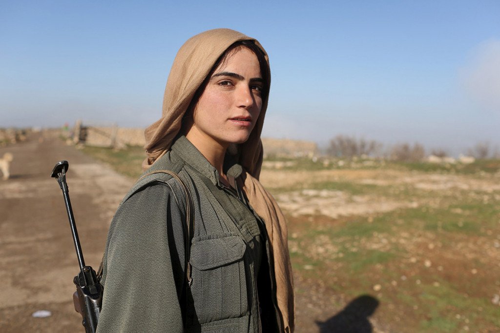 A female Kurdistan Workers Party fighter stands guard at a PKK base on Mount Sinjar in northwest Iraq (Asmaa Waguih/Reuters)