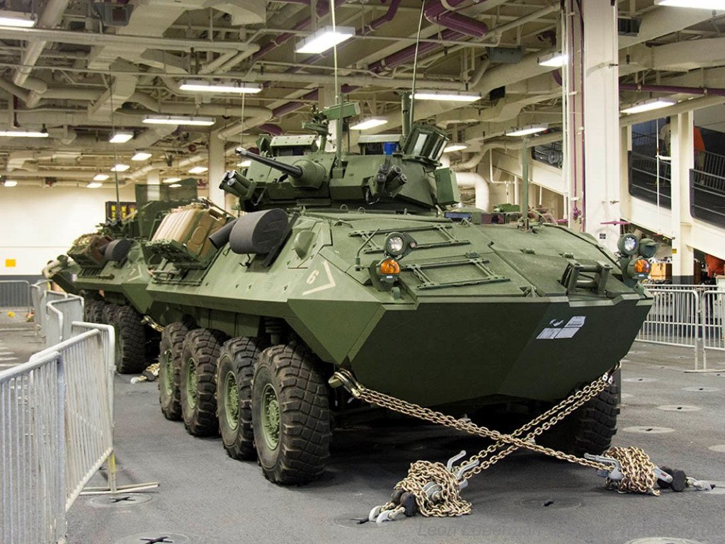 Light vehicle stowage deck inside LHA-6. The LAV-25 is a light armored reconnaissance vehicle which weighs approximately 12.8 tons.