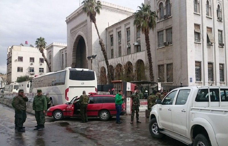 Security forces outside the Palace of Justice, a historic building in Damascus, on Wednesday, after a suicide bombing inside. Credit Agence France-Presse — Getty Images
