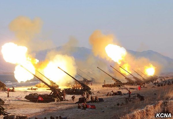 Koksan M-1989 heavy artillery batteries conducting live fire exercises on the western coast of North Korea.