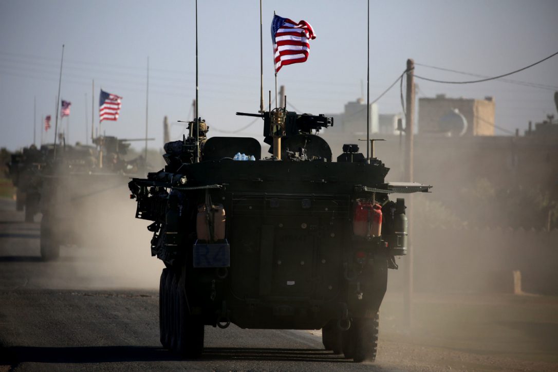 A March 5 photo shows a convoy of U.S. forces armoured vehicles driving near the village of Yalanli, on the western outskirts of the northern Syrian city of Manbij. Footage was posted Friday by Syrian activists online showed U.S. armoured vehicles driving on a rural road a few hundred meters from the Turkish border. (DELIL SOULEIMAN / AFP/GETTY IMAGES)